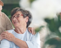 An image of a caregiver and senior woman talking