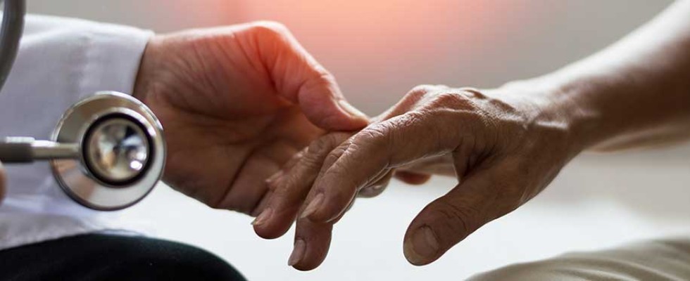 doctor's hand grasping patient hand