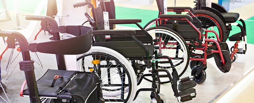 Multiple wheelchairs lined up in a row.