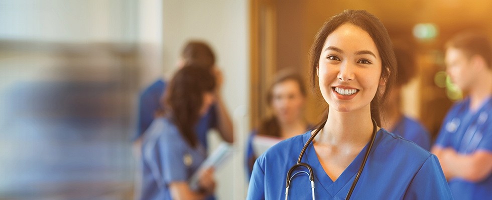 A nurse smiles at the camera