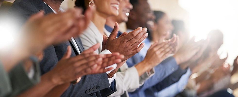 A group of people clapping