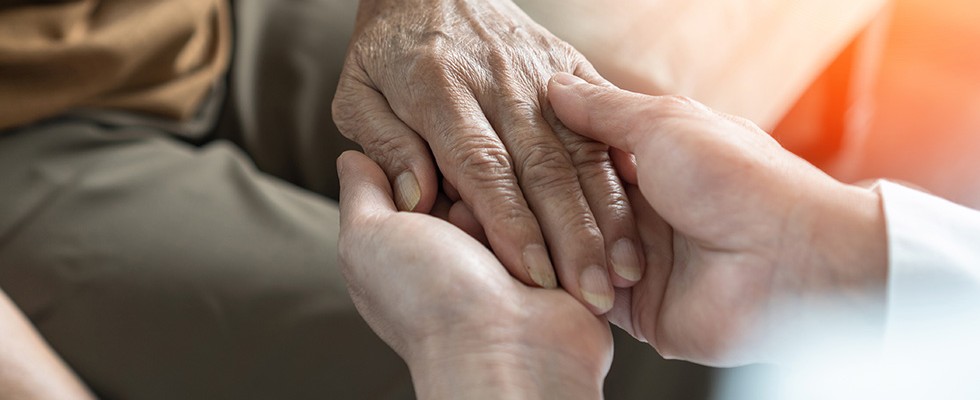 Two people holding hands. 