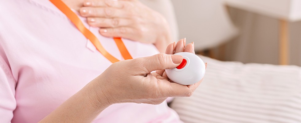 woman holding a personal emergency response system button