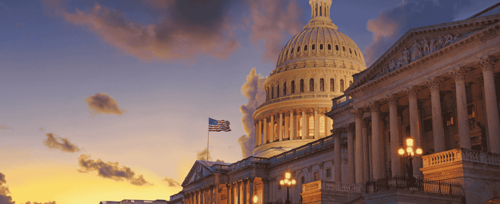 The Capitol building with an American flag and its sunset 