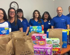 CenterWell team with food donations raised during their annual food drive.