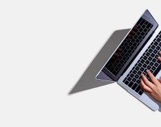 Hands typing on a laptop keyboard.