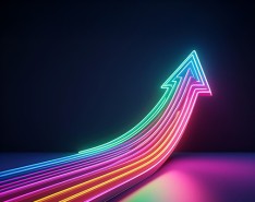 A multicolor neon arrow goes upward against a dark background