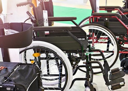 Multiple wheelchairs lined up in a row.